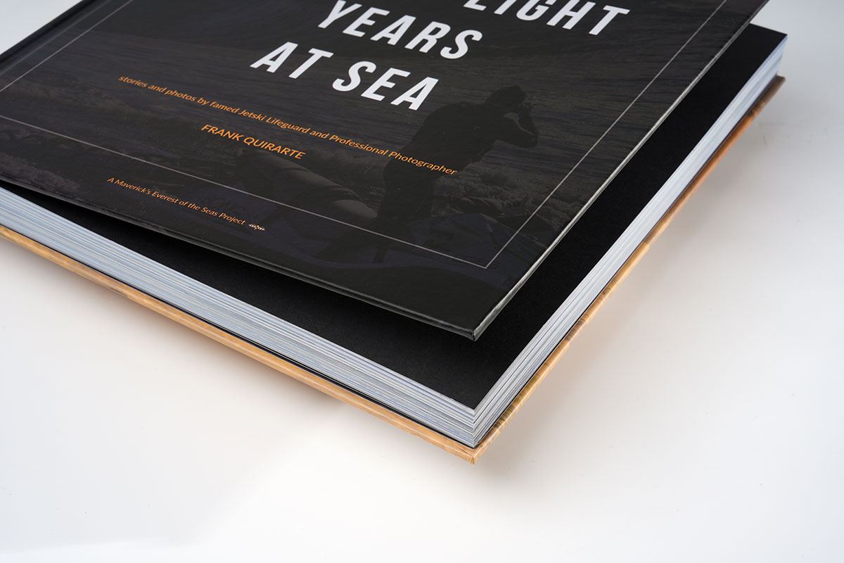 Lifted cover of a photography coffee table book revealing 3.5mm thick cover board and high-quality matte finish