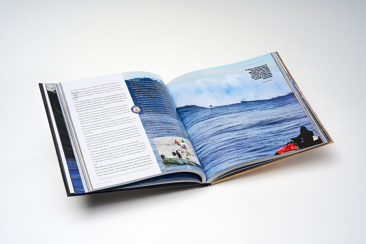 Flat-lay view of a hardcover photography coffee table book in 10x10 format, showcasing high-quality printing of big-wave surfing photographs