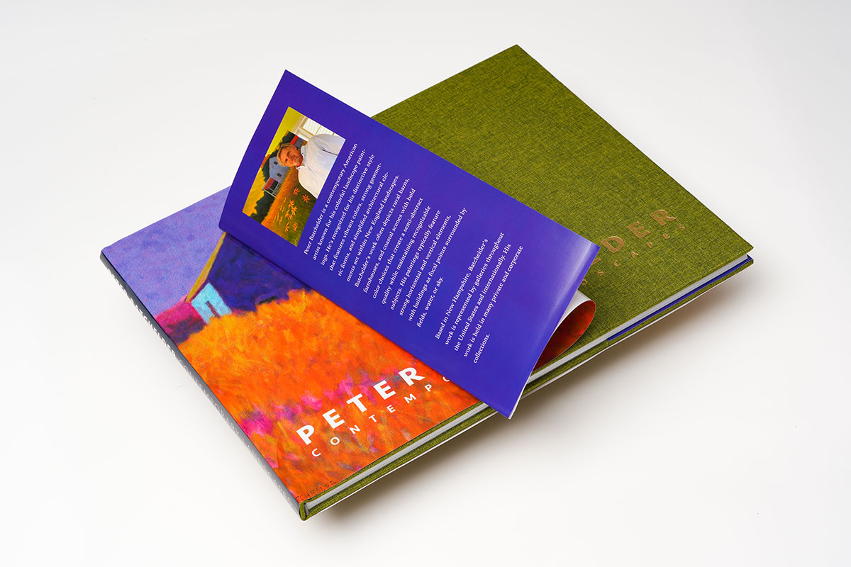 Hardcover coffee table art book with fabric cloth cover and dust jacket highlighting foil-stamped design and premium finish