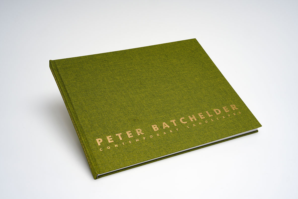 Close-up of fabric cloth-bound coffee table art book cover with foil stamping, showcasing durable 3.5mm board and high-quality craftsmanship