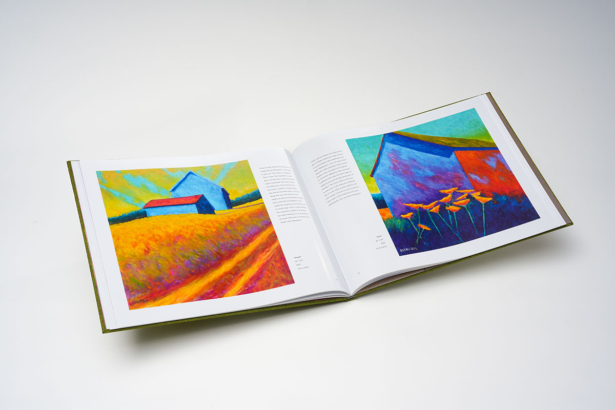 Flat-lay view of hardcover coffee table art book in 14x11 format, showcasing high-quality printing of contemporary landscape oil paintings