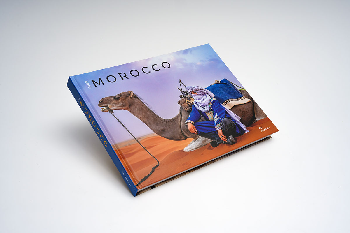 Hardcover travel photography coffee table book with matte lamination showcasing vibrant Moroccan landscapes and cultural images