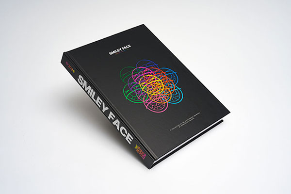 Hardcover sequential art sketchbook with matte lamination showcasing vibrant smiley face drawings