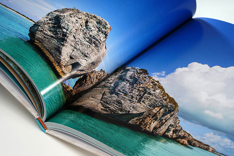 Open coffee table book spread showing full-color image reproduction