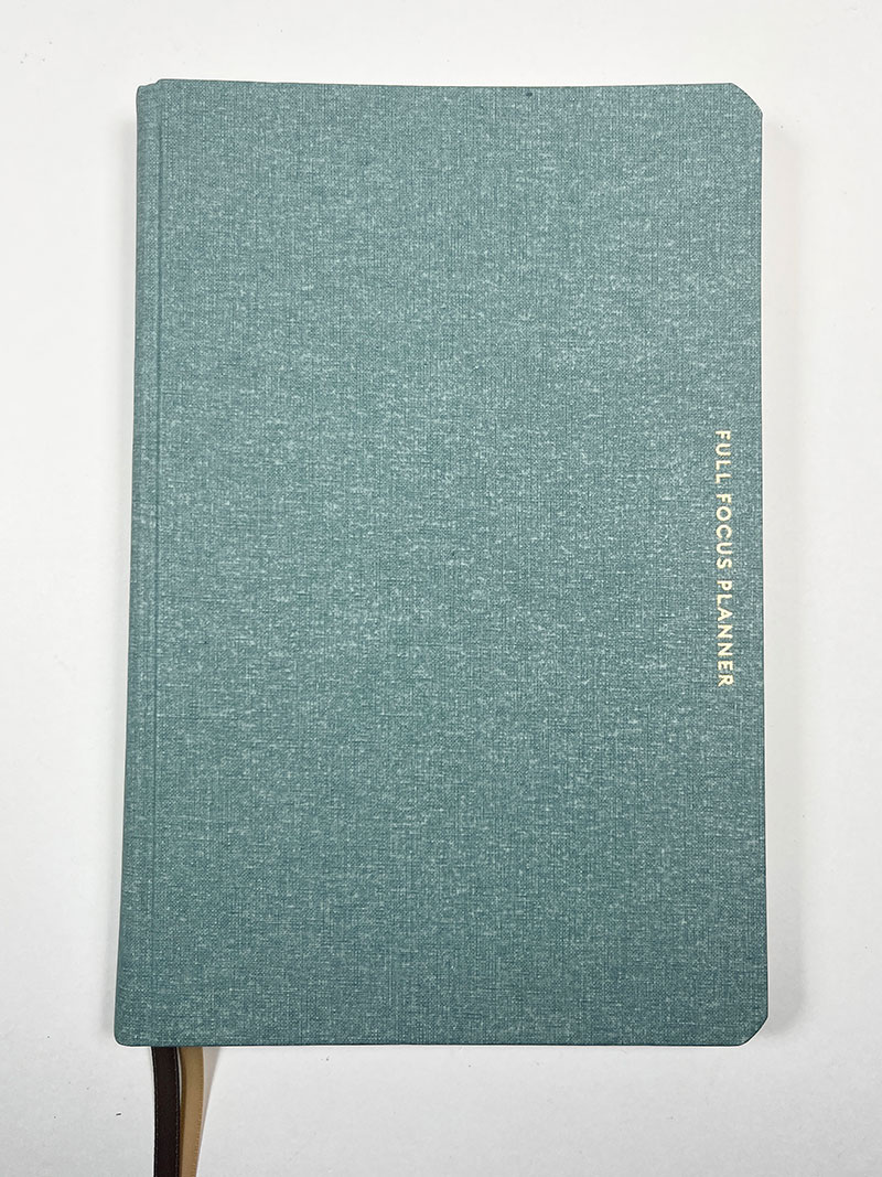 Image of foil stamping on a cloth book cover, showcasing a shiny, metallic design applied to the fabric surface.