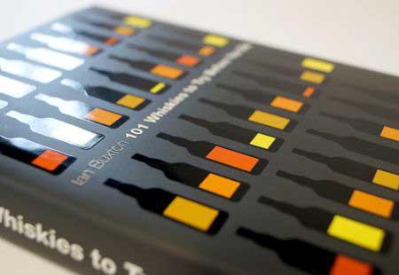 Close-up of spot UV application on a printed image, with glossy, raised patterns selectively applied over a matte black background