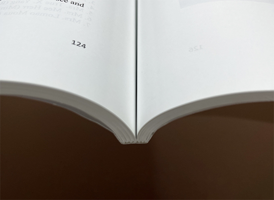 Softcover book block at the spine before cover finishing