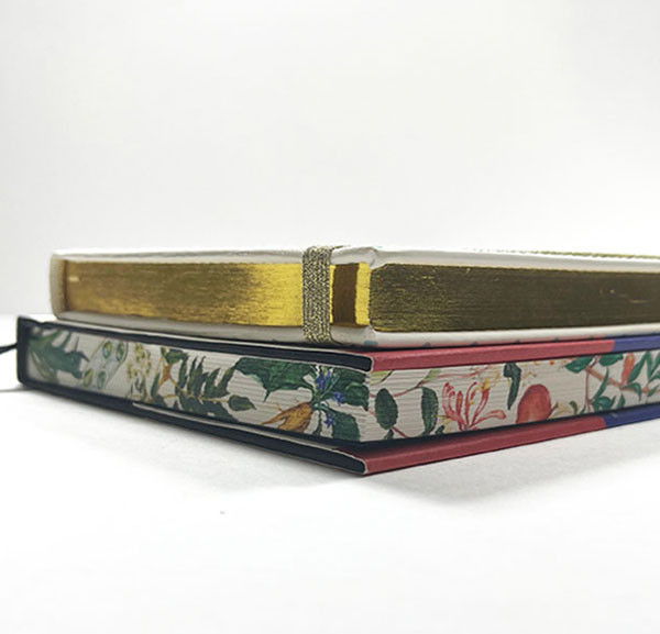 Two books with gold gilding and a digitally printed flower pattern on all book edges