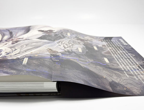 A 300-page large artbook featuring a fold-out page with uncoated art paper
